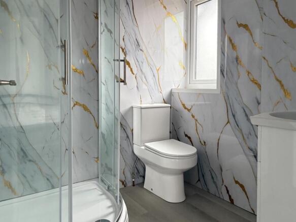 Modern bathroom with marble-effect tiled walls,...