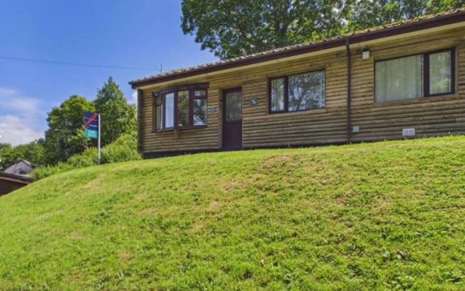 Exterior View Of The Timber Clad Lodge Set On A Gr