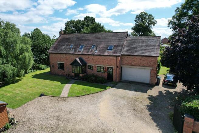 Front of house, double garage and shed