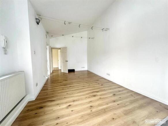 Bright living area with wood-effect flooring...