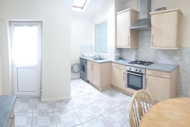 Bright, modern kitchen with light wood cabinets...