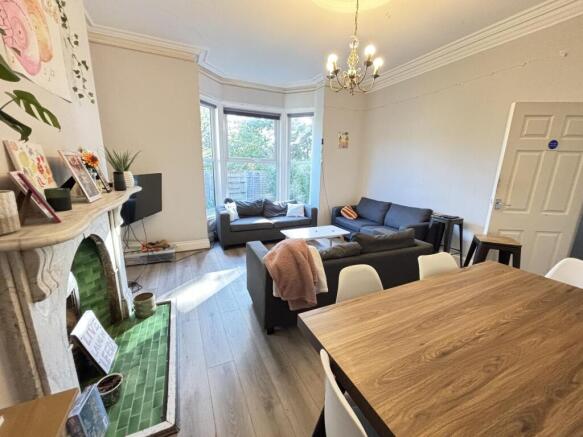 A bright and spacious living room with large wi...
