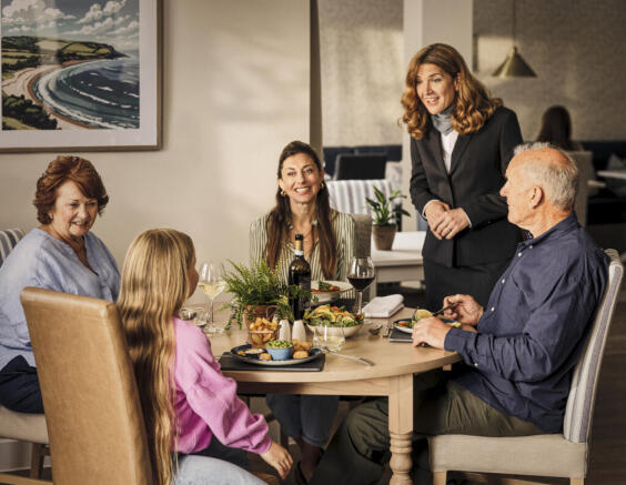 a group of people sitting around a table