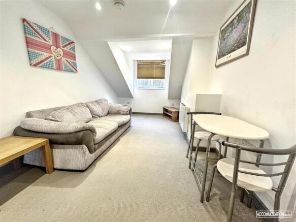 Bright lounge with plush sofa and dining area...