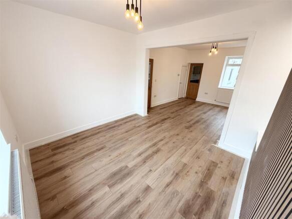 Bright open-plan living area with modern floors...