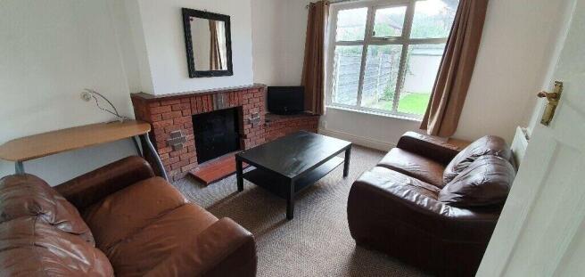 Bright, cozy living room with leather sofas...