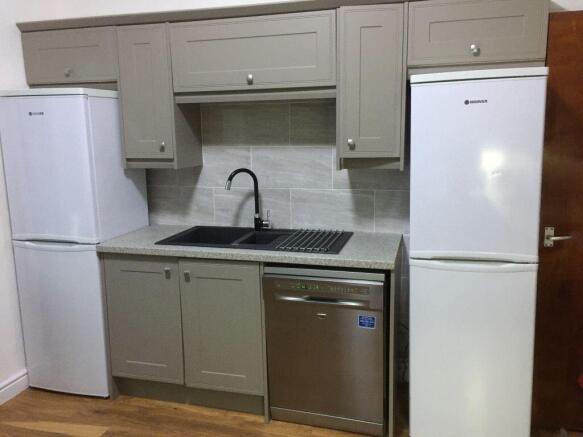 Modern compact kitchen with neutral cabinetry, ...