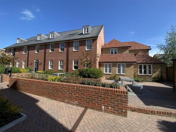 Well-kept brick-front property with neat courty...