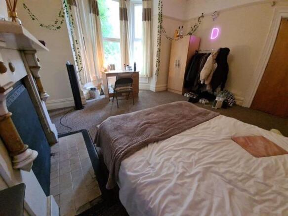 A spacious and well-lit master bedroom featurin...