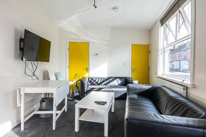 Bright lounge with leather sofas and smart TV...
