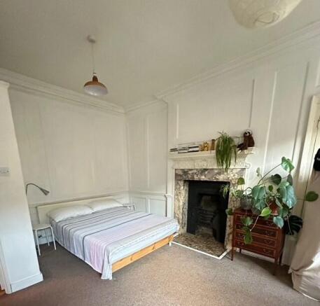 Bright master bedroom with feature fireplace...