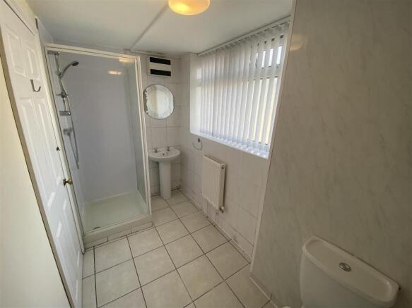 Bright modern bathroom with large shower cubicl...