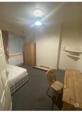Spacious bedroom with ample storage and desk...