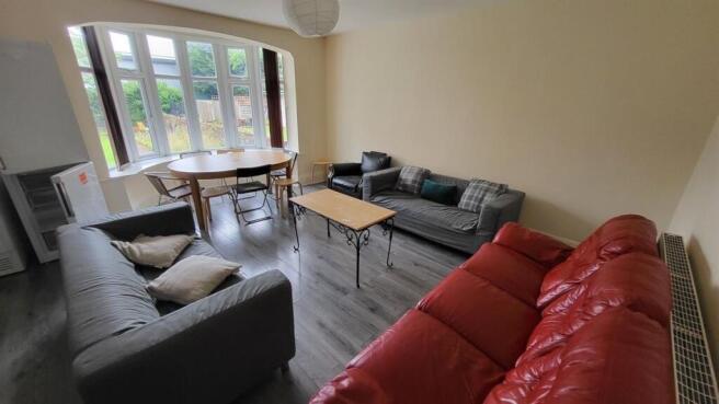 Bright, well-furnished living room with multipl...