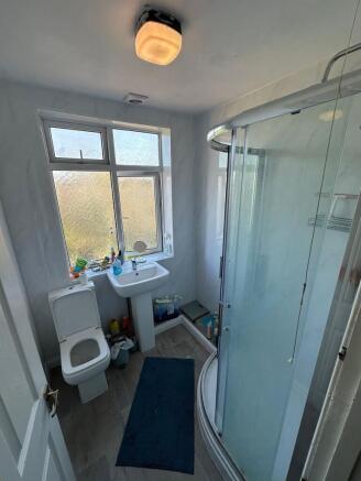 Bright bathroom with modern corner shower unit....