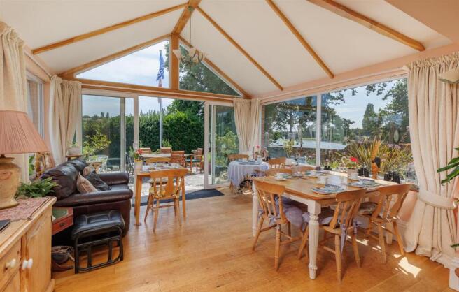 Dining room/conservatory with doors opening to gar