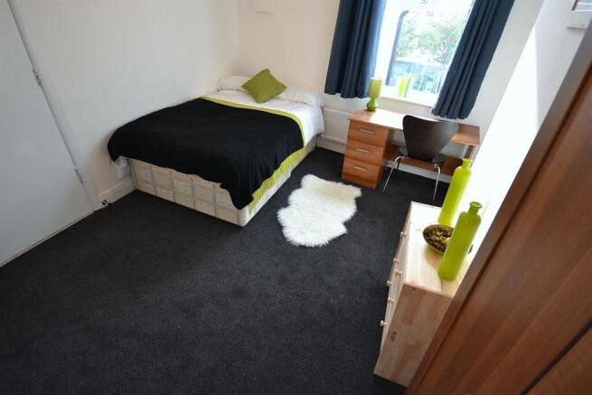 Bright bedroom with double bed and study desk...