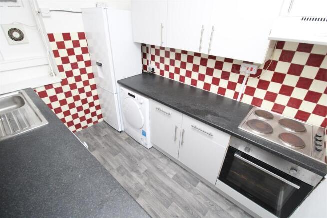 Bright kitchen with modern appliances and stora...