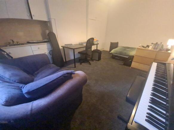 Spacious shared living room with multiple seati...