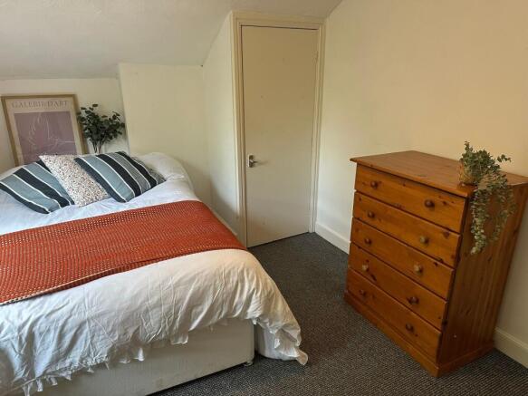 Cozy and inviting double bedroom featuring a co...