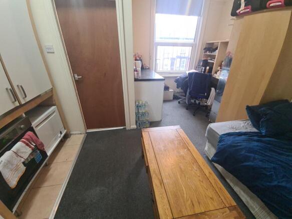 A compact and tidy single bedroom featuring a c...