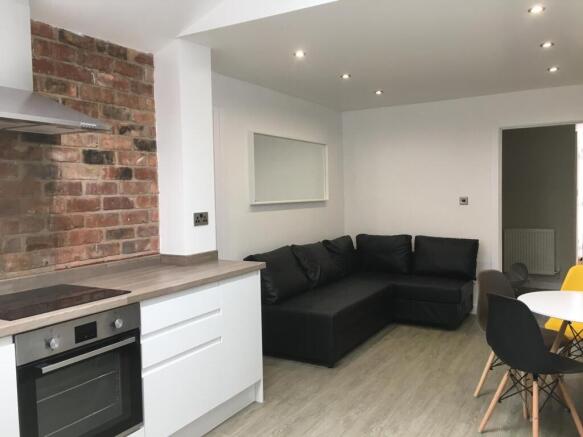 Modern open-plan living area with a fitted kitc...