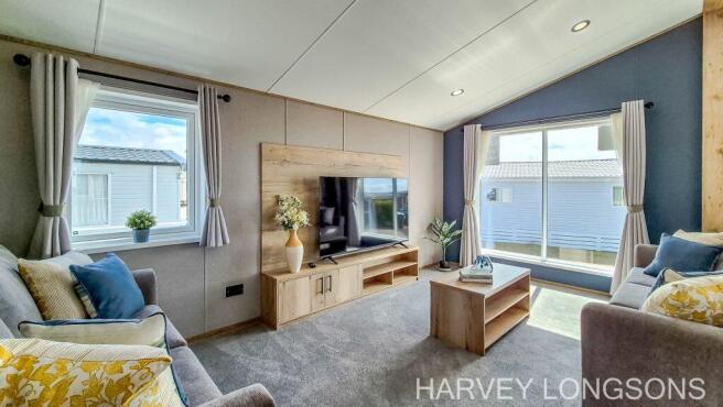 Bright lounge with TV and large windows in the ABI