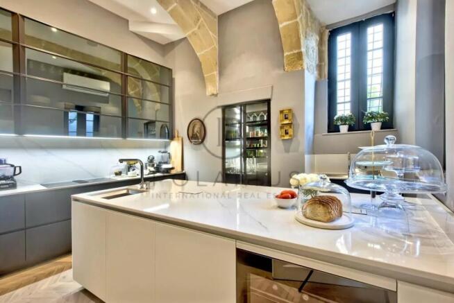 Modern kitchen with sleek cabinetry, a white marbl