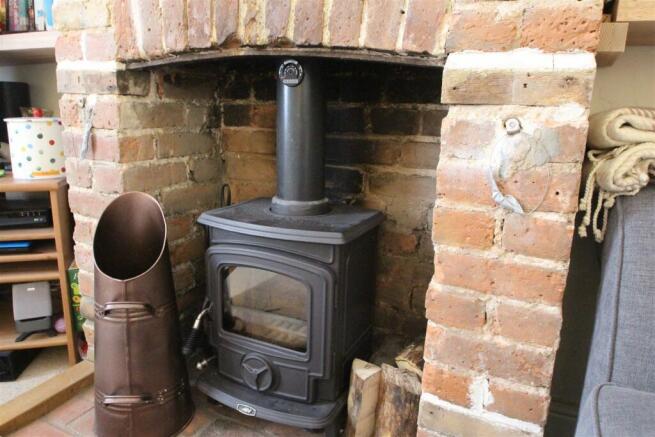 FEATURE BRICK FIREPLACE WITH LOG BURNER