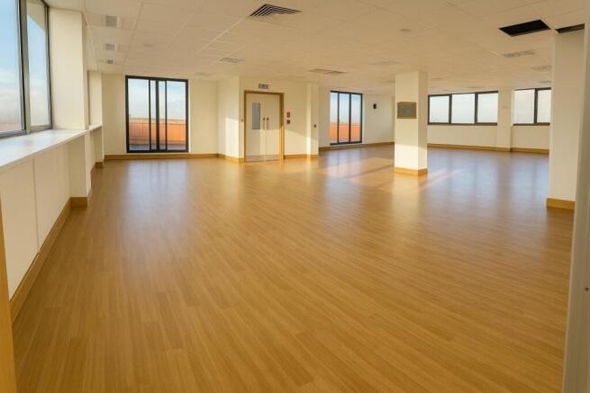 Spacious, bright open-plan workspace with wood-...