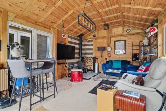 Reception room leading onto garden with log burner