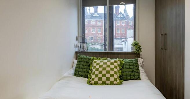Bright bedroom with double bed and large window...