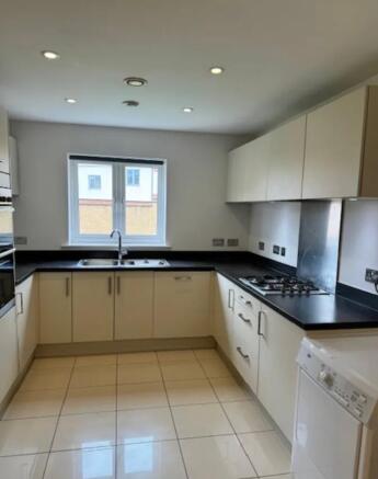 Bright modern kitchen with a U-shaped black cou...
