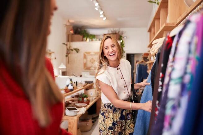 Two Female Friends Shopping In Independent Clothin