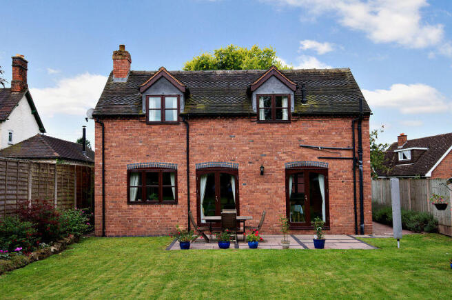 Property from the rear showing access to patio are