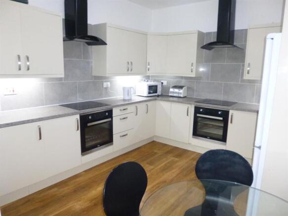 Bright, modern kitchen with dual electric ovens...