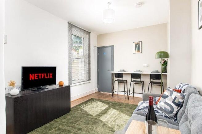 Bright lounge with smart TV and breakfast bar...