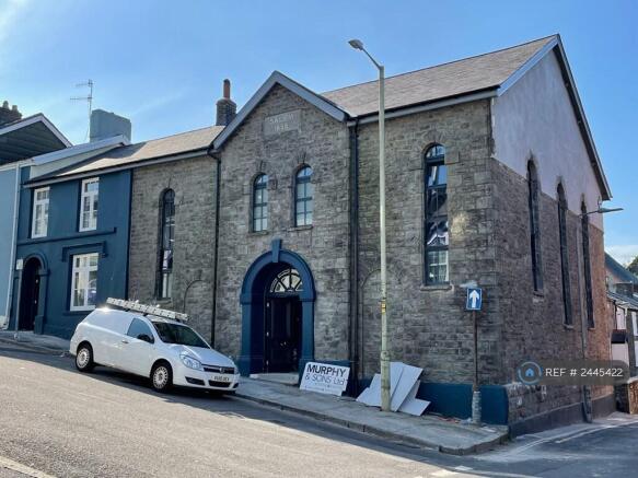 Blue Building Adjacement To Methodist Church