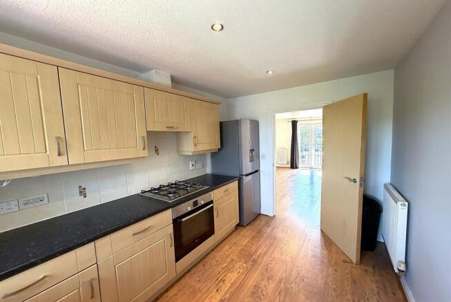 Bright kitchen with modern wooden cabinets...