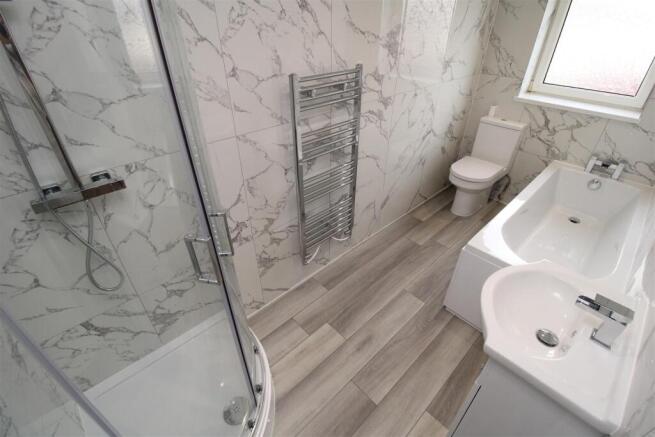 Modern bathroom with marble tiling and bath....