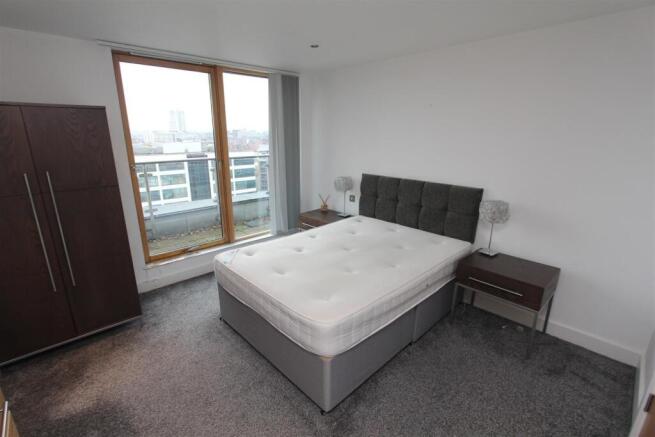 Bright modern bedroom with floor-to-ceiling vie...