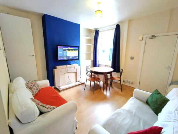 Bright, neatly presented living room with two c...