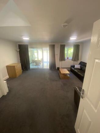 Spacious lounge with seating and patio access...