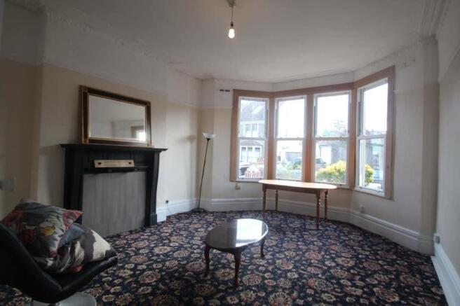 Spacious lounge with a bright bay window...