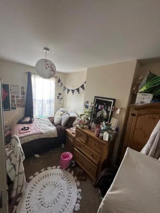 A cozy double bedroom with warm lighting and pe...