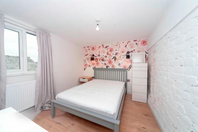 Bright double bedroom with floral feature wall...