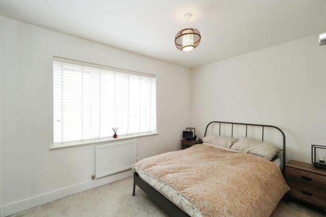 The master bedroom with smoked glass built in wardrobes