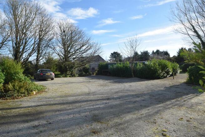 EXTENSIVE GRAVELLED PARKING AREA