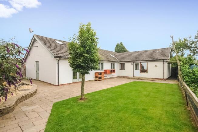 Rear view of the bungalow with level garden