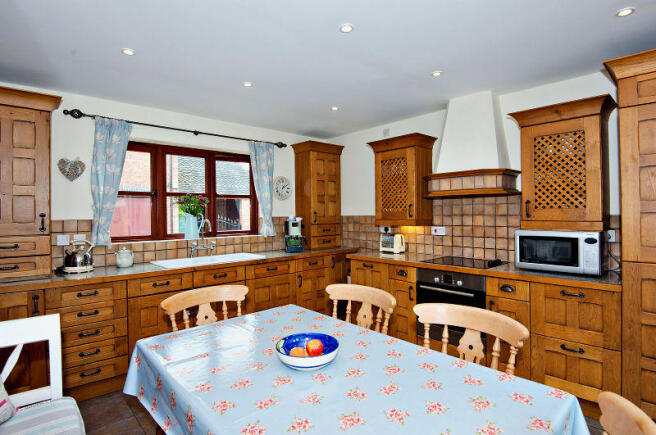 Kitchen showing solid oak units with window onto c